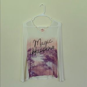 sweater says “magic happens”